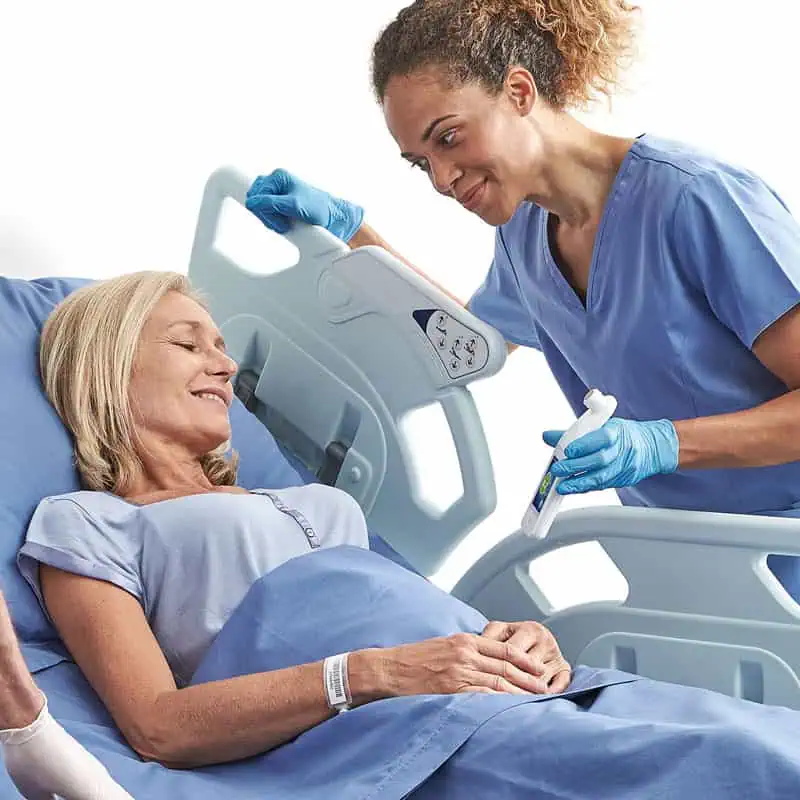 Nurse demonstrating the use of the Provizio SEM Scanner to a female patient in a hospital setting, highlighting patient education.